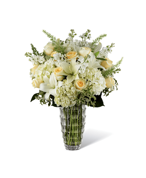 Offering a ray of light within what can be a dark place when grieving the loss of a loved one, The FTD Hope Heals Luxury Bouquet is a unique and sophisticated way to show how much you care for your recipient and the memory of the deceased. An exquisite arrangement designed by our floral experts, this gorgeous bouquet brings together ivory roses, fragrant white gilly flowers, clouds of white hydrangea and star-shaped white Asiatic Lilies. Accented with asparagus fern fronds and variegated foliage, this sympathy bouquet is presented in a keepsake faceted clear glass vase to create an exceptional look that is not only a tribute to a life well lived, but a comfort to those left behind. Approx. 25 inchH x 21 inchW.