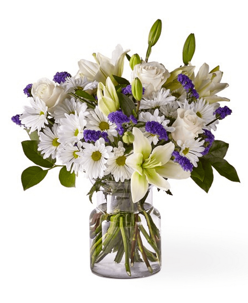 There is something about the shade of blue that brings a sense of calmness and serentity. Beyond Blue bouquet is designed with billowing white blooms and pops of bold florals to deliver just the right sentiment for any occasion. 18 inchHx16 inchW