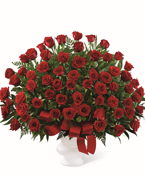 The FTD Soul's Splendor Arrangement is a rich display of the love shared throughout the life of the deceased. Brilliant red roses are elegantly displayed in a white designer plastic urn and accented with lush greens and red satin ribbon to create a beautiful tribute to honor your special relationship. 32 inchW x 32 inchH