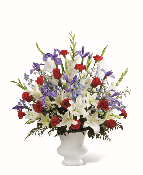 A dramatic floral salute respectfully features a heroic color palette of red, white and blue t honor the life of a hero. Our Gratitude Arrangement is designed with lilies, irises, delphinium and roses t share your sympathies with reverence and respect. While the lilies may initially arrive in bud form, they beautifully transform as they open. 
Good arrangement is approximately 32 inchH x 26 inchW
Better arrangement is approximately 35 inchH x 29 inchW 
Best Arrangement is approximately 36 inchH x 30 inchW 