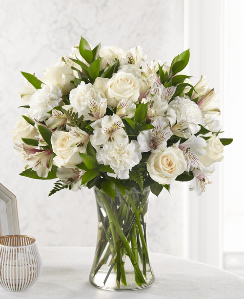 For the friends wh truly feel like family, share your thoughts and love with timeless white flowers. Our Cherished Friend bouquet is comprised of a striking array of alstroemeria, carnations and roses. Each bloom combines your thoughtful messages with stunning texture. 
Good bouquet is approximately 16 inchH x 14 inchW 
Better bouquet is approximately 17 inchH x 16 inchW 
Best bouquet is approximately 18 inchH x 17 inchW 