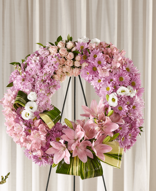 When someone you know is going through a difficult time, our Gift of Warmth Wreath shares your support. An array of pink and lavender blooms in a classic shape is thoughtfully crafted by a local florist t express your sympathy. 
Wreath is approximately 25 inch in diameter 