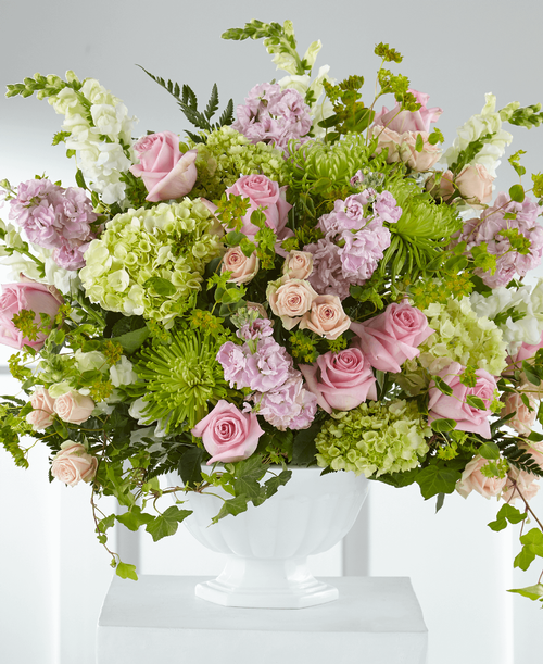 Elegantly crafted with an array of pink and green blooms, this bouquet shares your messages of sympathy with grace. Our Radiant Embrace is handcrafted with hydrangea, spider mums, roses and snapdragons by a local florist t celebrate the life of a dear loved one. 
Good arrangement is approximately 17 inchH x 19 inchW 
Better arrangement is approximately 21 inchH x 22 inchW 
Best arrangement is approximately 23 inchH x 24 inchW 