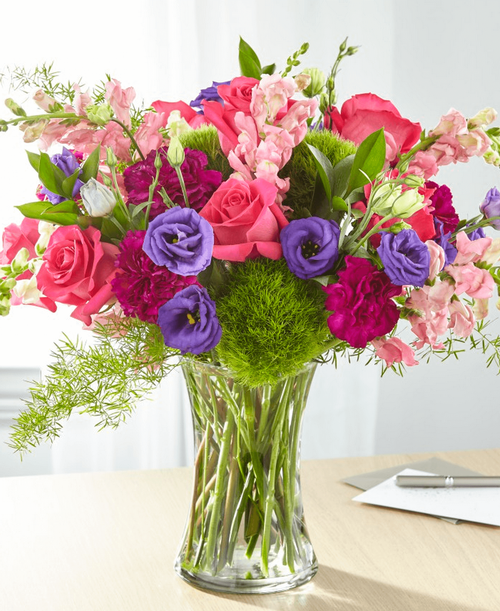 Charm and comfort are evoked through a refined array of bright flowers. A stunning bouquet to show that you are here for those you care about during difficult times of loss. 17 inchHx19 inchW