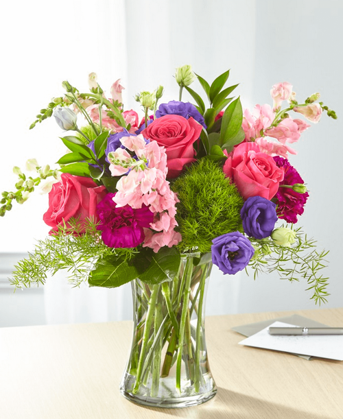 Charm and comfort are evoked through a refined array of bright flowers. A stunning bouquet to show that you are here for those you care about during difficult times of loss. 16 inchHx18 inchW