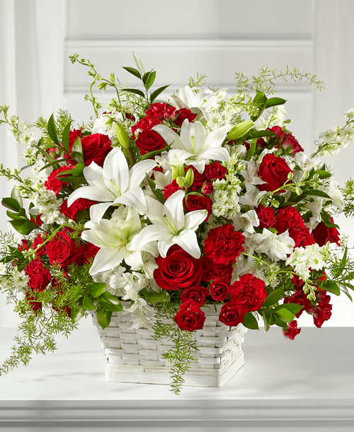 Our Sentiments of Love Arrangement is crafted with bold red and soft white blooms t beautifully display your respects during times of sensitivity. Each bloom is composed with grace and elegance as it is placed by a local florist in a white basket. It features a unique collection of lilies, roses, larkspur and carnations that is fit t send t either a home or service. 
Good arrangement is approximately 20 inchH x 25 inchW 
Better arrangement is approximately 22 inchH x 27 inchW 
Best arrangement is approximately 24 inchH x 29 inchW