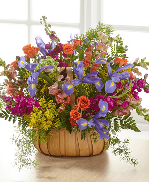 A gorgeous mix of beautiful, bright summer flowers offers an uplifting expression of your sympathy and love. 17 inchHx24 inchW