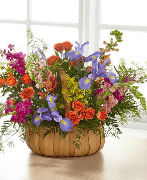 A gorgeous mix of beautiful, bright summer flowers offers an uplifting expression of your sympathy and love. 16 inchHx23 inchW