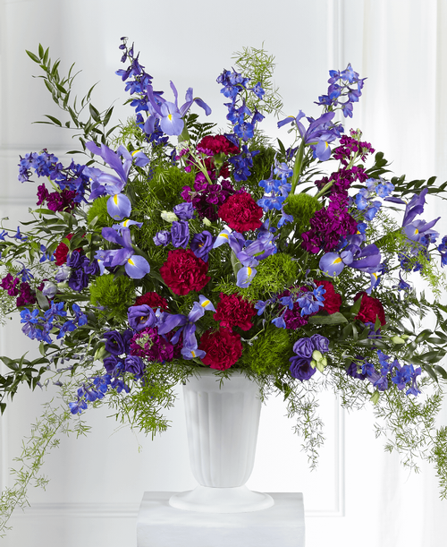 With our Memorial of Life Arrangement, an enchanting mix of purple and blue florals are accented by lush greens t share solace with loved ones. An array of stock, lisianthus and delphinium make this fresh bouquet a stunning piece t express your love and comfort during times of sensitivity. 
Good arrangement is approximately 32 inchH x 34 inchW 
Better arrangement is approximately 34 inchH x 36 inchW 