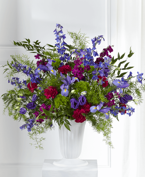 With our Memorial of Life Arrangement, an enchanting mix of purple and blue florals are accented by lush greens t share solace with loved ones. An array of stock, lisianthus and delphinium make this fresh bouquet a stunning piece t express your love and comfort during times of sensitivity. 
Good arrangement is approximately 32 inchH x 34 inchW 
Better arrangement is approximately 34 inchH x 36 inchW 