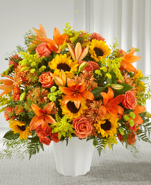 Whether autumn was their favorite season or you just want t bring comfort during this difficult time, our Harvest Thoughts Arrangement beautifully shares your sympathies. Bursting lilies fill this basket with texture and are complemented by bright sunflowers, roses and pompons. 
Good basket is approximately 25 inchH x 27 inchW 
Better basket is approximately 27 inchH x 34 inchW 