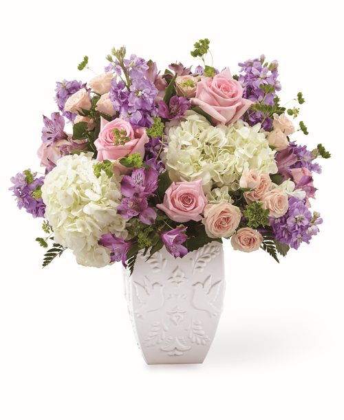 Send your condolences with a stunning arrangement that includes with hydrangea, spray roses and stock. Each gorgeous flower in our FTD Peace and Hope Lavender Bouquet is complimented by an elegant dove and leaf patterned vase to lift them up.
Good bouquet is approximately 15 inchH x 16 inchW, Better bouquet is approximately 17 inchH x 18 inchW, Best bouquet is approximately 18 inchH x 20 inchW 